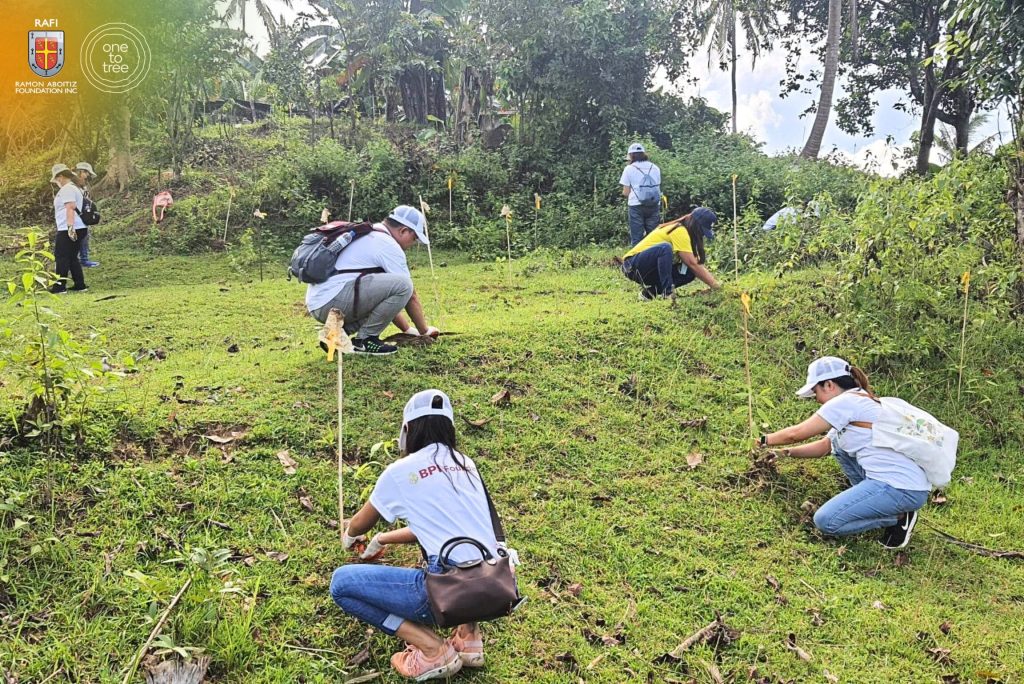 Volunteers from BPI planting tree seedlings at project site